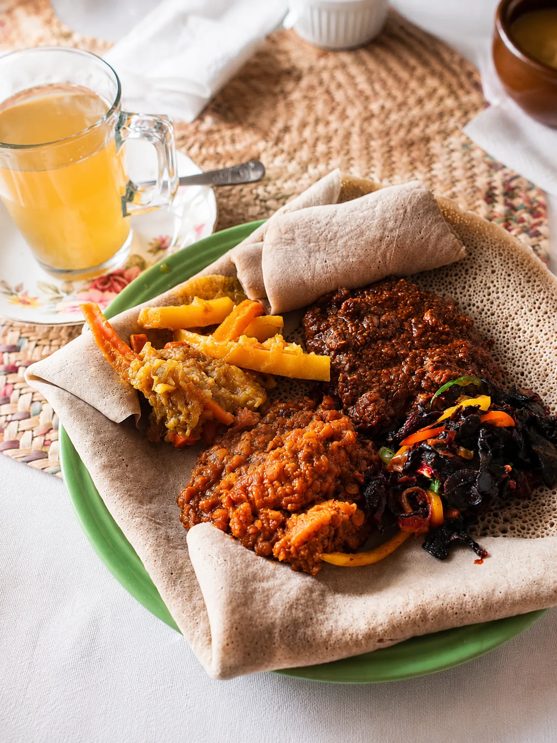 An Ethiopian combination platter served with a cup of tea